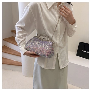 Iridescent sequin evening clutch bag with silver chain strap shown in a lifestyle setting