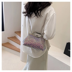 Sparkling sequin evening bag worn as a shoulder bag against a minimalist white background