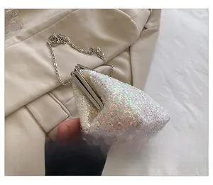 Side view of iridescent sequin clutch bag featuring silver chain and kiss-lock closure