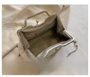 Detail of the sequined evening bag interior with lining, zipper pocket, and metal handle