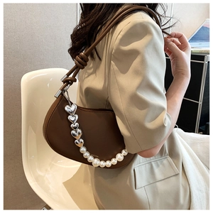 Brown half-moon bag with elegant pearl heart chain and stylish knotted shoulder strap