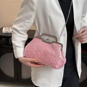 Pink sequin evening clutch bag with chain strap and metal clasp shown on model