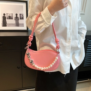 Pink crescent shoulder bag with pearl heart chain and knotted strap for daily wear