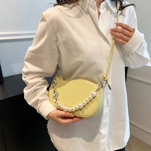 Chic light yellow crescent shoulder bag with pearl chain and heart pendant accessory