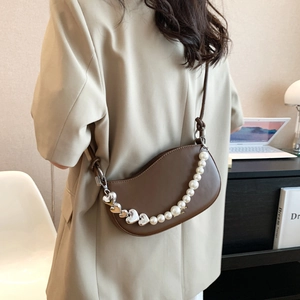 Brown leather half-moon crossbody bag with decorative pearl heart chain for office style