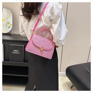 Detail of pink sequin crossbody bag showing glitter texture and gold swivel lock