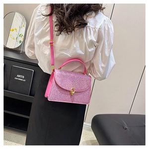 Detail of pink glitter texture and gold metal buckle on stylish women's crossbody bag