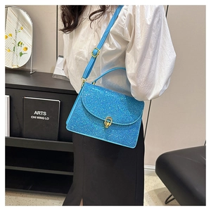 Detail of blue glitter crossbody bag with gold ring buckle and adjustable shoulder strap