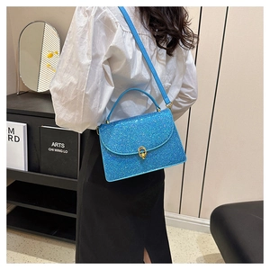 Close-up of glittery blue crossbody bag showing shimmering texture and gold ring hardware
