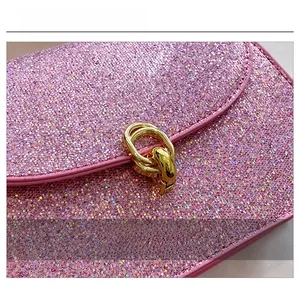 Detail of pink glitter texture and premium gold metal double-ring buckle on lady handbag