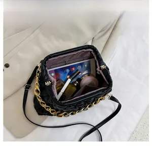 Interior view showing the large capacity of a quilted cloud bag with tablet and makeup