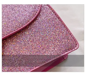 Detailed view of pink sequin fabric with leather edges on a small crossbody bag