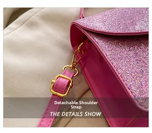 Detail of pink glitter shoulder bag with gold metal hardware and detachable strap