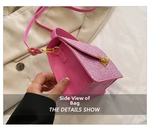 Close-up of pink crossbody bag side with glitter flap and golden metallic hardware lock