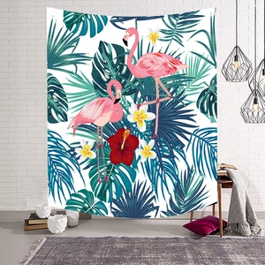 Nordic tapestry featuring pink flamingos and tropical palm leaves on a white brick wall