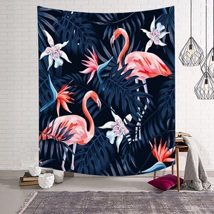Detail of tropical tapestry with flamingos and palm leaves hanging on a white brick wall