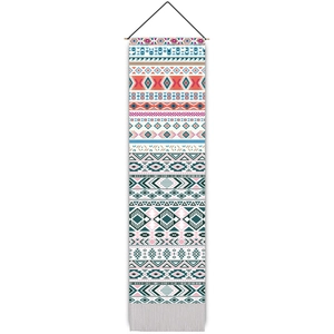 Detail of bohemian woven tapestry featuring colorful geometric patterns and white fringe