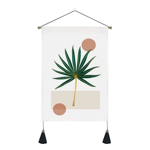 Close-up of abstract palm leaf tapestry with elegant black tassels and hanging rod