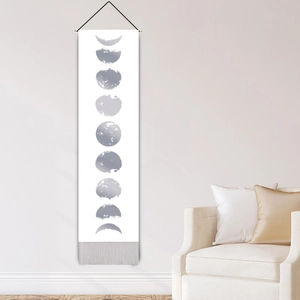 Nordic moon phase wall tapestry with silver cycles and decorative fringe on white wall