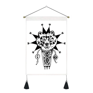 Bohemian black and white wall tapestry featuring a bear head design with tassels