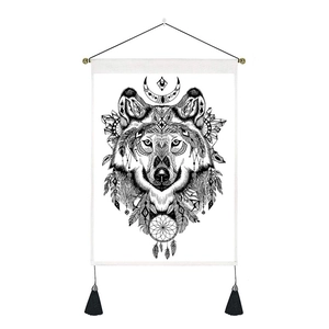 Detail of bohemian wall tapestry featuring a wolf head dreamcatcher with black tassels