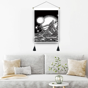 Monochrome ocean wave tapestry with tassels hanging in a minimalist modern living room