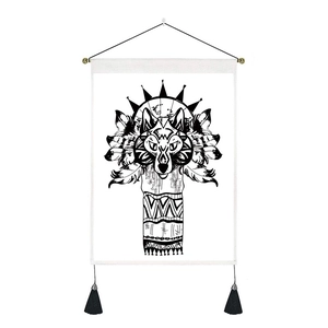 Detail of tribal wolf head tapestry with geometric patterns and long black tassels