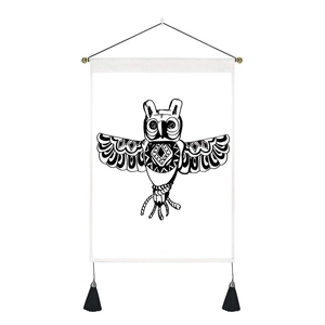 Detail of bohemian owl wall tapestry featuring ethnic patterns and black silk tassels