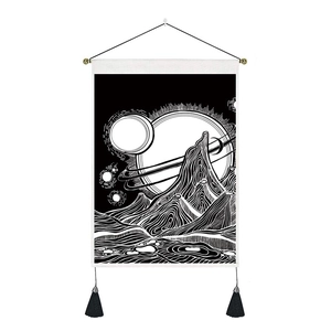 Detail of black and white celestial tapestry featuring starry sky and mountains with tassels