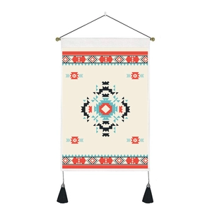 Detail of geometric diamond pattern tapestry with black tassels and wooden hanging rod