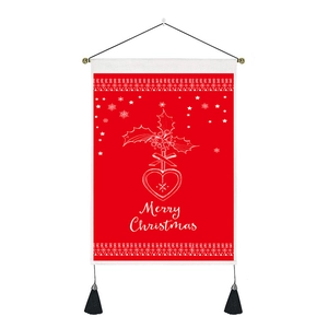 Detail of red Merry Christmas wall tapestry with holly patterns and black tassels