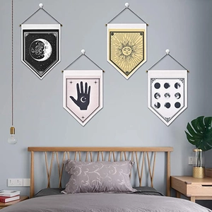 Detail of four bohemian wall banners with celestial moon and sun prints on linen fabric