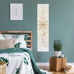 Bohemian tapestry featuring moon phases and mystical eyes with elegant white tassels