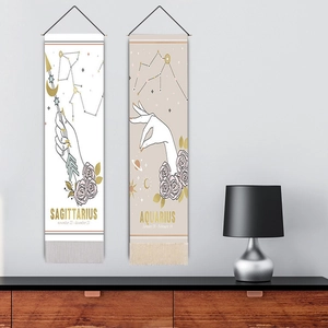 Pink tarot hanging tapestry with Sagittarius and Aquarius signs, tassels, and wood frame