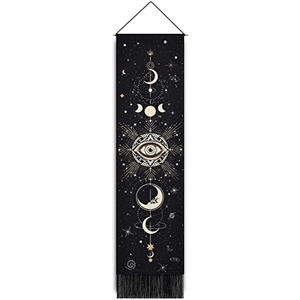Bohemian black wall tapestry with moon phases, all-seeing eye, stars, and black fringe detail