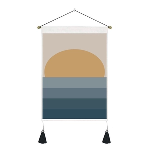 Detail of Nordic tapestry with abstract sunset design, wooden pole and black tassels