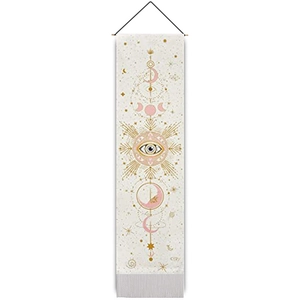 Macro view of bohemian sun and moon tapestry with celestial eye and white tassel trim