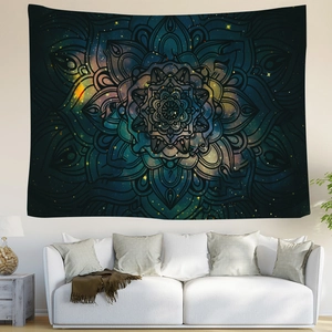 Detail of hippie mandala tapestry with nebula print hanging over a white sofa