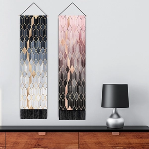 Geometric tapestry wall hanging with diamond patterns and black fringe for living room