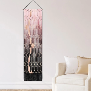 Modern geometric hanging tapestry with pink and gray diamond patterns and black tassels