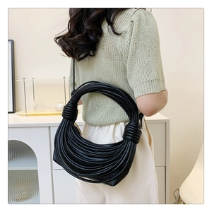 Detailed close-up showing the unique multilayer leather coil weaving on the black hobo bag