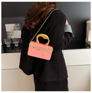 Detailed shot of pink marble acrylic bag with unique gold handle and chain strap