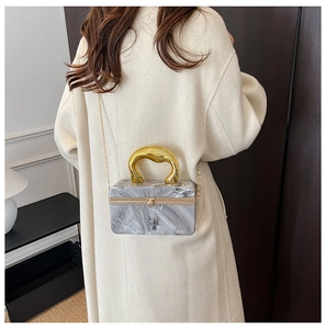 Elegant marble pattern box bag styled with a beige coat for a sophisticated party look