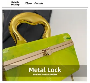 Detail of green marble acrylic clutch with elegant gold metal hardware and secure latch lock