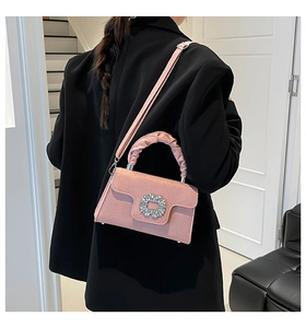 Pink pleated handbag with crystal buckle shown in a stylish crossbody outfit display