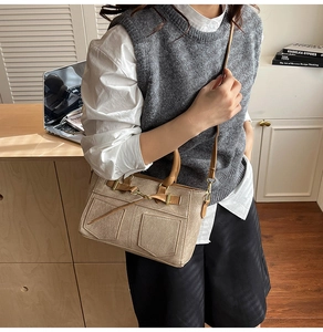 Detail of khaki patchwork canvas bag with denim style pockets and brown handles