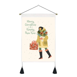 Close-up of Merry Christmas tapestry featuring a girl illustration with black tassels