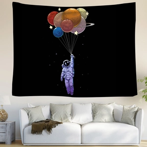 Detailed astronaut tapestry with colorful planet balloons hanging over a white sofa