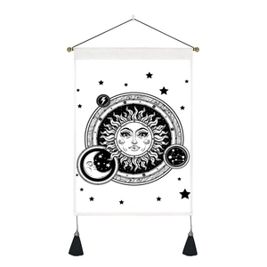 Macro detail of sun and moon tapestry with black tassels and fine canvas texture