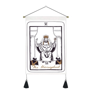 Macro detail of The Hierophant tarot tapestry with golden crown and black tassels